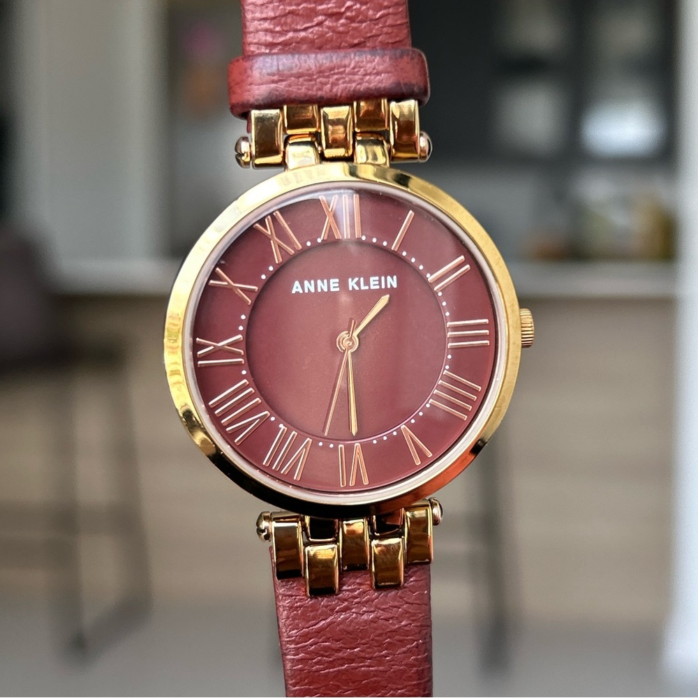 Burnt red, round face Anne Klein watch in good condition